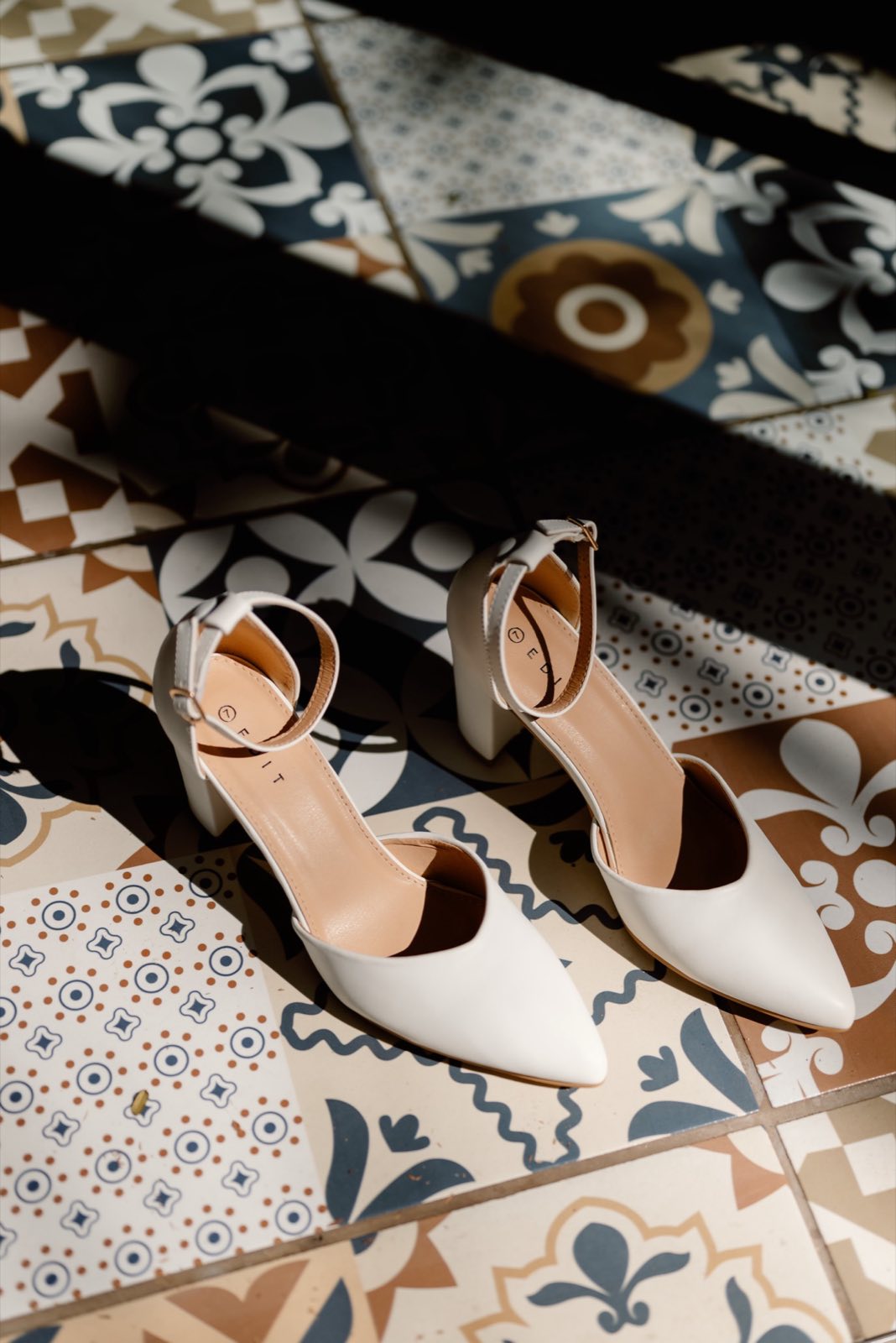 Bridal shoes on patterned tiles