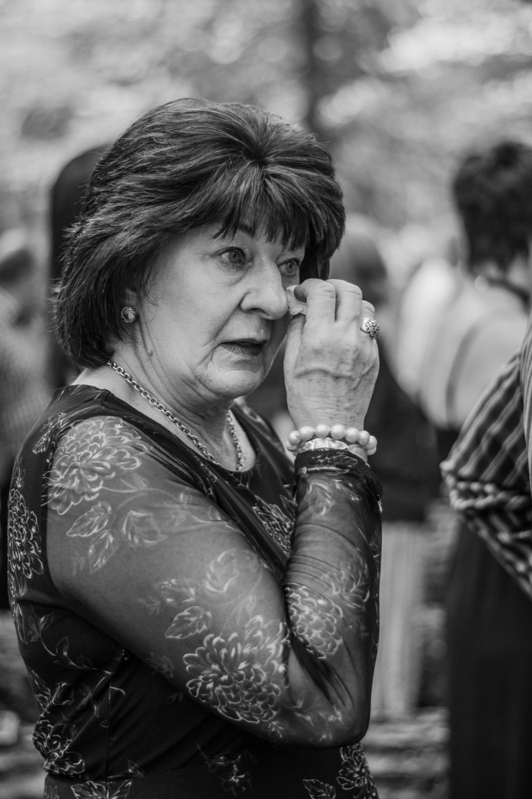 Wedding guest wiping away a tear during the ceremony
