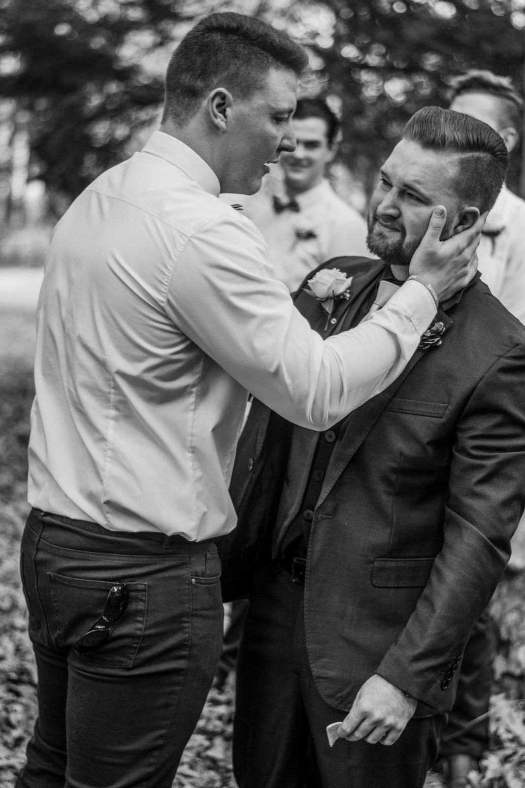 A tender moment between two grooms during the wedding day