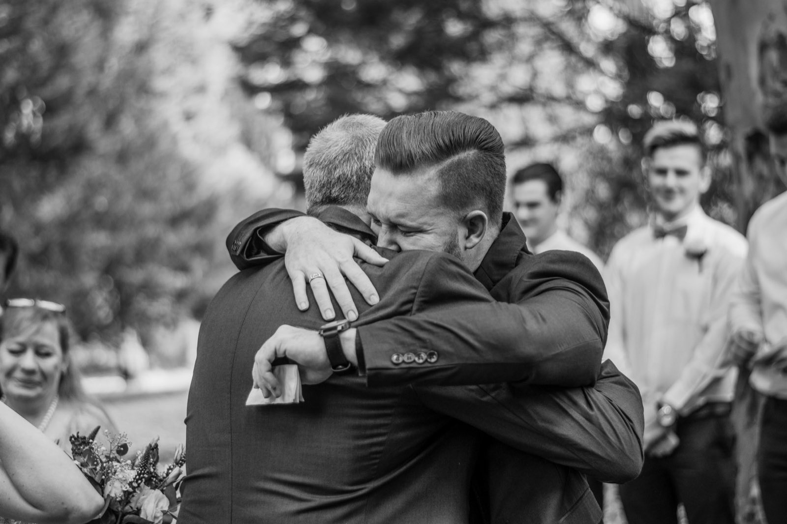Groom embracing a loved one during the celebration
