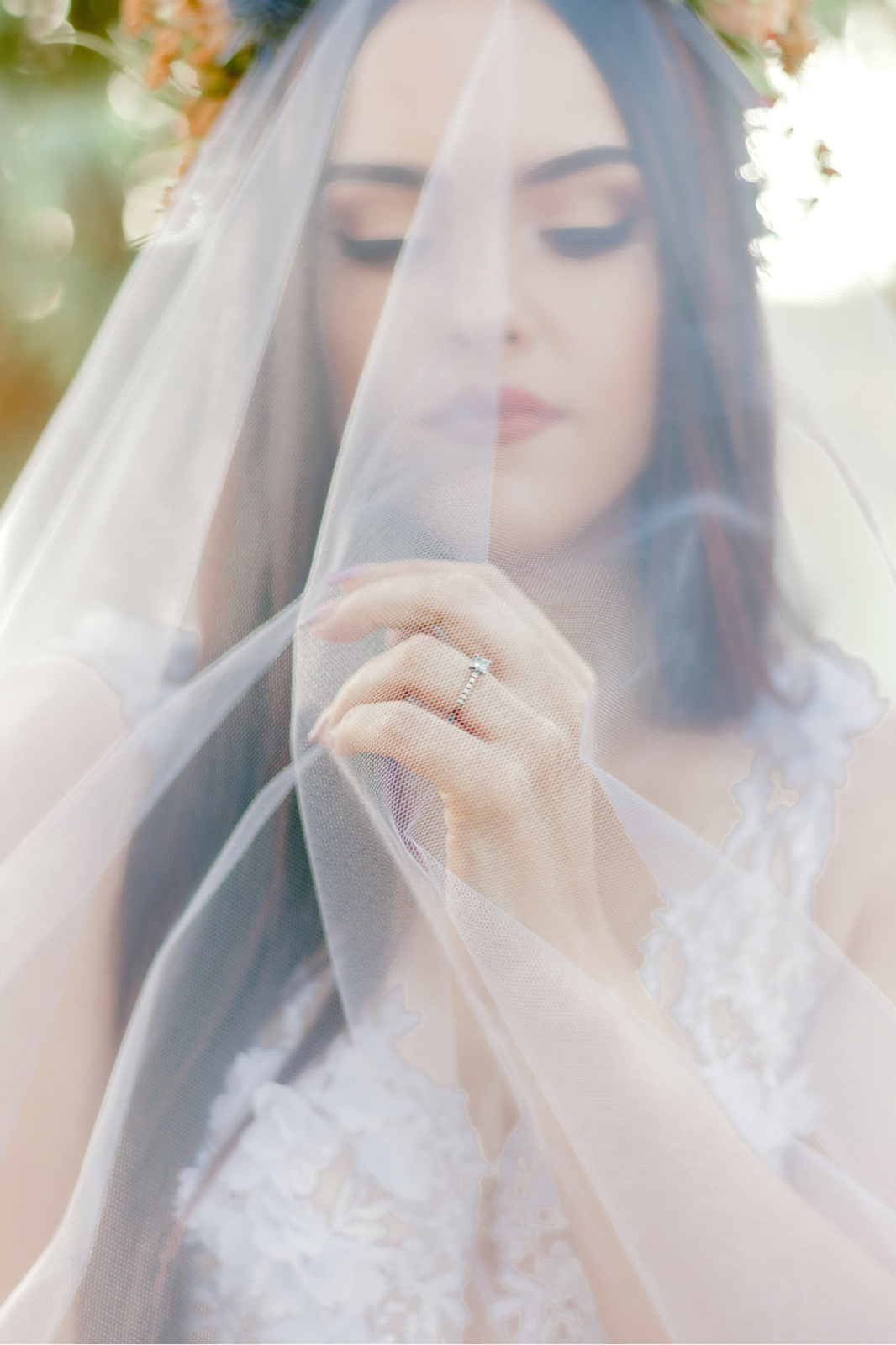 Soft-focus bridal portrait behind a veil